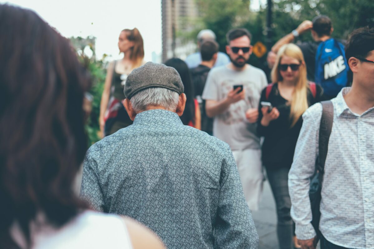 Old man in mobile savvy crowd