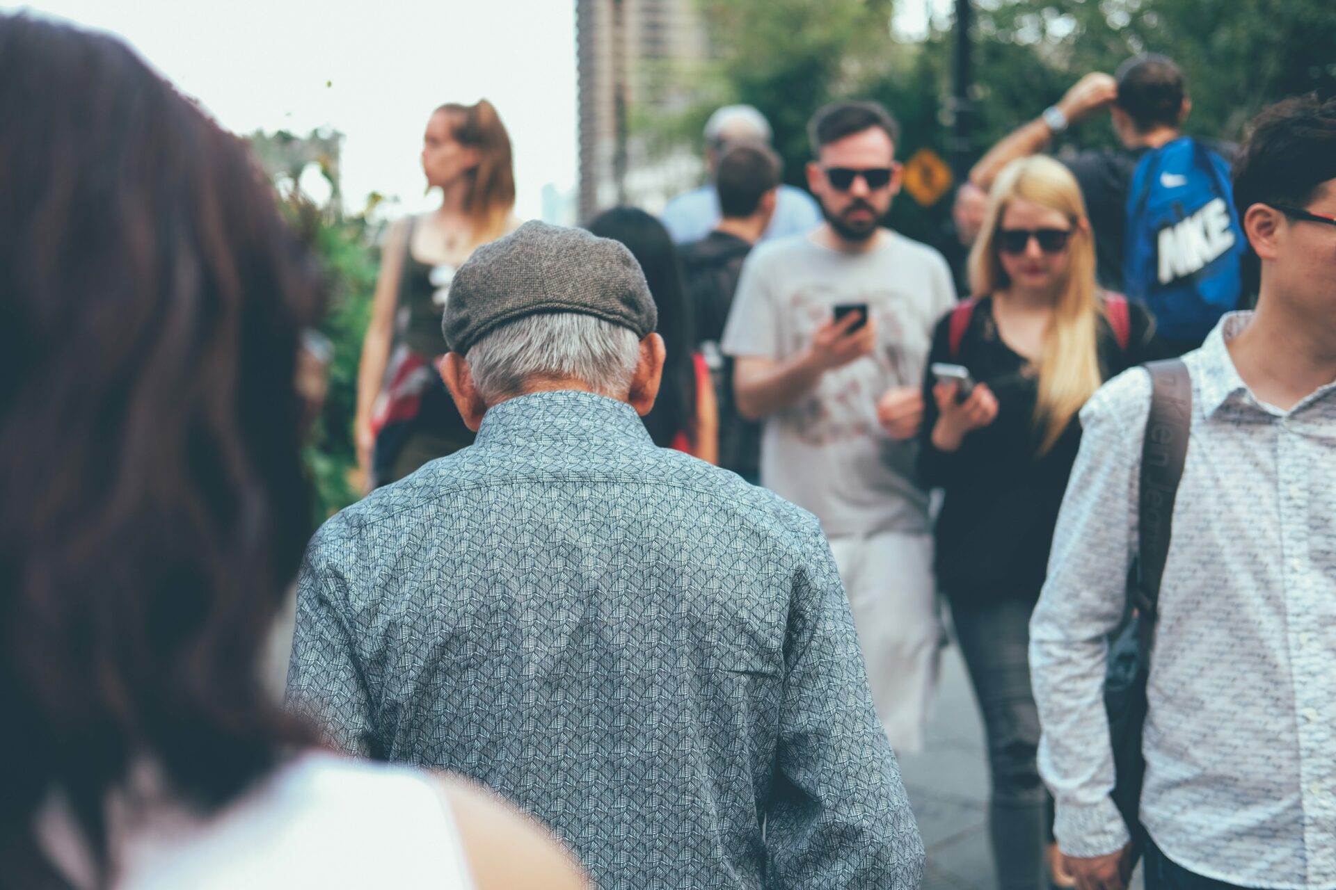 Old man in mobile savvy crowd